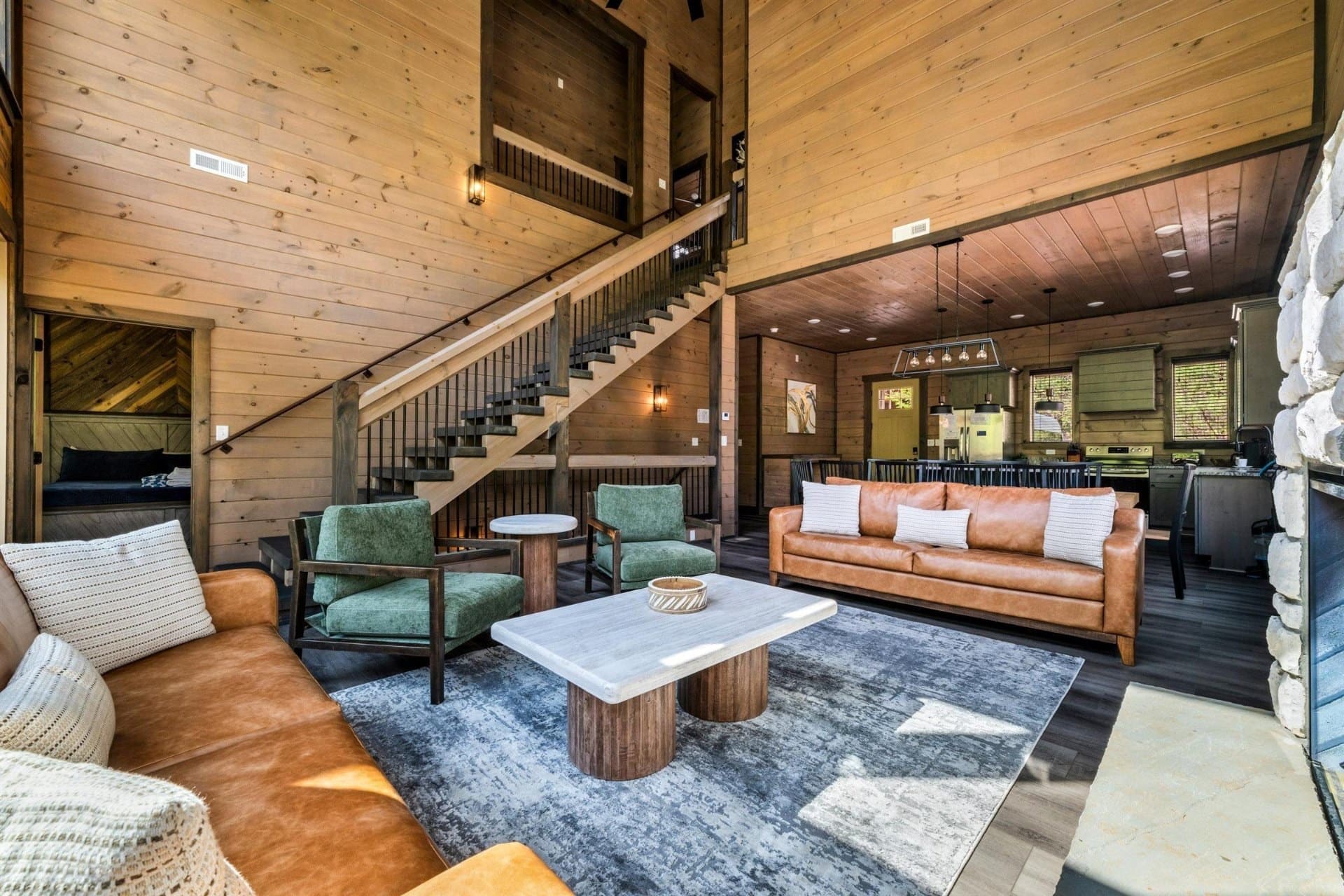 Builder walking through a luxury timber-framed Smoky Mountain cabin under construction