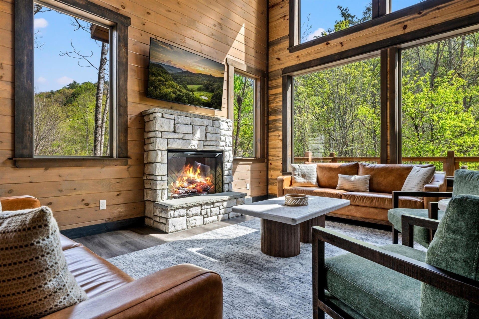 Luxury Smoky Mountain vacation rental great room with fireplace at golden hour
